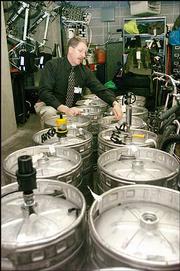 Lawrence Police Lt. David Cobb, looks over some of the 16 kegs of
beer, some still full, after the police raided a Feb. 19 party at
the Phi Kappa Theta fraternity house, 111 W. 11th. Kansas
University's Interfraternity Council's judiciary board voted Monday
to expel the fraternity from the university's campus. The
fraternity plans to appeal the decision chapter president Matt
Moreno said.