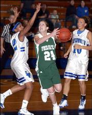 Free State High's Jenna Brantley, center, shoots around two
Leavenworth defenders. The Firebirds lost, 50-41, in a Class 6A
sub-state game Thursday night at Leavenworth, ending their season.