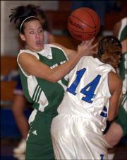 Free State High's Lauren Kimball, left, is tangled up with
Leavenworth's Leslie Combs. The Firebirds lost, 50-41, Thursday
night at Leavenworth.
