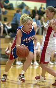 Oskaloosa's Kari Bellinger, left, drives around Osage City defender
Dani Carson. The Bears lost, 53-40, in Class 3A sub-state play
Thursday night in Wellsville.