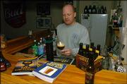 Andy Booth pours one of his homemade beers from a tap in his home.
Booth's Firehouse No. 2 Ale is a tribute to his job as a
Lawrence-Douglas County Fire & Medical firefighter.