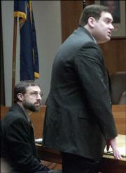 Martin K. Miller, left, appears in Douglas County District Court
with his attorney Mark Manna, right, in his preliminary hearing on
a charge that he asphyxiated his wife, Mary Miller. Judge Paula
Martin ruled Wednesday that there was enough evidence for a trial,
and set a date in June.