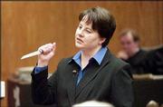 During closing arguments in Douglas County District Court,
Assistant Dist. Atty. Angela Wilson demonstrates to the jury how
Carmin D. Ross was murdered. Wilson held a 6-inch boning knife, the
same type that was missing from Ross' kitchen after she was found
dead in her home northwest of Lawrence in November 2003. Ross'
ex-husband, Thomas E. Murray, is charged in her death.