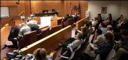 Spectators and members of the media filled the courtroom Monday for
closing arguments. At far left, defense attorneys counsel with
defendant Thomas E. Murray, who is charged in the slaying of his
ex-wife, Carmin D. Ross. The jurors heard closing arguments Monday
before beginning deliberations.