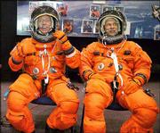 Astronauts Michael Fossum, left, and Piers Sellers wear training
versions of their launch and entry suits in the space vehicle
mockup facility at Johnson Space Center in Houston. Fossum and
Sellers, who are on the crew for the next Atlantis mission, also
would fly on a rescue mission to bring back the Discovery
astronauts if that shuttle were damaged during flight.