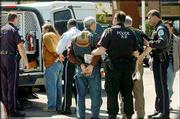 Demonstrators are arrested outside Woodside Hospice in Pinellas
Park, Fla. Protesters symbolically tried to smuggle bread and water
to Terri Schiavo, whose feeding tube was removed Friday.
