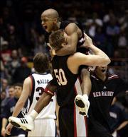 Texas Tech's Ronald Ross jumps in the arms of Joey Hawkins (50)
after the Red Raiders defeated Gonzaga, 71-69. Tech won the
second-round NCAA Tournament game Saturday in Tucson, Ariz.