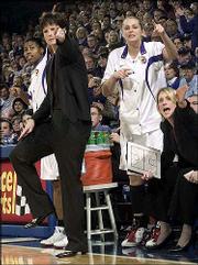 KU coach Bonnie Henrickson, second from left, states her case for
an out-of-bounds call as players Alicia Rhymes, left, Jamie Boyd,
second from right, and assistant coach Katie O'Connor make their
opinions known in this file photo from KU's 63-45 loss to Kansas
State on Jan. 8 at Allen Fieldhouse.