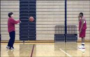 First-year Kansas University women's basketball coach Bonnie
Henrickson, left, rebounds the ball for junior forward Crystal Kemp
after a Dec. 4 practice at Horesji Center.