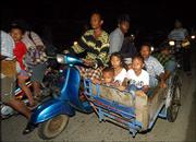 Acehnese cram onto a scooter and cart as they drive to higher
ground after an earthquake in Banda Aceh, Indonesia. A major
earthquake struck off the west coast of Indonesia's Sumatra Island
late Monday, and officials warned that a tsunami could strike the
area. Residents of Banda Aceh fled their homes in panic.