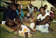A Sri Lankan family, survivors of the Dec. 26 tsunami, listen for
updates of emergency procedures following a massive earthquake off
the coast of Indonesia. The family has lived for more than three
months at a temporary shelter for the displaced in Colombo, Sri
Lanka.