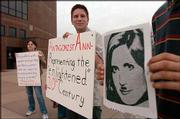 Stephanie Kirmer, 20, Lawrence, and Jim Boyd, 27, Lawrence, protest
outside the Lied Center, where right-wing commentator Ann Coulter
spoke Tuesday to an estimated crowd of 1,800 people.