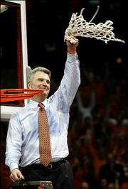 Illinois coach Bruce Weber waves the net after the Illini defeated
Arizona in the Chicago Regional championship. Weber celebrated
Saturday in Rosemont, Ill.