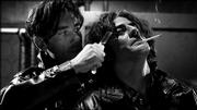 Clive Owen, left, threatens Benicio Del Toro in filmmaker Robert
Rodriquez's stylish adaptation of "Sin City."