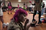 Peggy Noland, aka Estee Slaughter, prepares for competition in the
Roller Warriors all-female roller derby league.