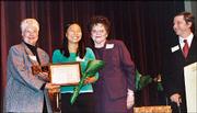 Yuan Liu, of Lawrence, second from left, receives the Wallace
Galluzzi 2004 Youth Volunteer of the Year award at the United Way
of Douglas County annual meeting Feb. 24. Presenting the award is
Dee Bisel, left, and Marie Galluzzi Potter. David Morrissey,
manager of the Roger Hill Volunteer Center, looks on.