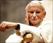 Pope John Paul II smiles from his papal throne, in this May 16,
1990, file photo, during his weekly general audience. The pope died
Saturday in his Vatican City apartment. Tens of thousands of
mourners gathered below his window in St. Peter's Square to mourn
his passing.