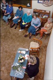 Meadowlark Garden Club members recently had a meeting with Cindy
Goldring, foreground, floral manager at Hy-Vee, Clinton Parkway and
Kasold. She gave a demonstration on how to make a floral
arrangements.