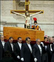 The wooden casket bearing the remains of Pope John Paul II is
carried into St. Peter's Square at the Vatican. World leaders and a
million mourners attended the funeral Mass for the pontiff Friday.
