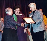 Lenora Crumet, left, volunteers for the Douglas County Visiting
Nurses Assn., receives recognition as a Wallace Galluzzi 2004
Volunteer of the Year honoree at the United Way of Douglas County
annual meeting. Marie Galluzzi Potter, center, and Dee Bisel
presented Crumet with flowers and a certificate Feb. 24.