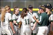 Free State High softball coach Pam Pine, second from right, meets
with her players between innings of an 11-1, first-game loss to
Shawnee Mission Northwest. The Firebirds lost both games of a
doubleheader Friday at FSHS.