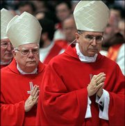 U.S. Cardinals Bernard Francis Law, left, and Michael Roger Mahony
arrive for a Mass on Friday at the Vatican. They will participate
in the conclave to elect a new pope that begins Monday.