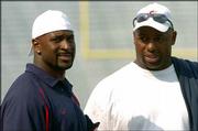 Former KU standouts now in the NFL, Don Davis, left, and Dana
Stubblefield visit during the spring game.