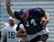 Former Jayhawk Keith Loneker runs the ball during the KU football
alumni game. The Blue team beat the White team, 21-15, Saturday
afternoon at Memorial Stadium.