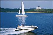 Boats work their way around Table Rock Lake in Branson, Mo. Resorts
like the 10-story Chateau on the Lake Resort and Conference Center,
seen at rear right, offer AAA four-diamond lodging and conference
facilities.