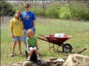 From left, Gabi, Rebecca and Elizabeth Gant take a break from
helping clean April 10 at Hidden Valley Camp in Lawrence. The camp
was established for Girl Scout use in 1956.