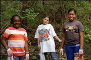 From left, Girl Scouts Mariam Ali, Devon Lohrenz and Raven Graves
help during a spring cleanup at Hidden Valley Camp, just northwest
of Kasold Drive and Bob Billings Parkway. The work day was April
10.