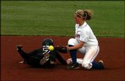 Kansas second baseman Jessica Moppin, right, misses a tag on
Missouri's Amy Henke in the top of the third inning.