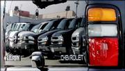 A line of full-size SUVs, vans and other trucks are reflected in
the tailgate of a Chevrolet Suburban at a General Motors dealership
in Glendale, Calif. Hulking SUVs have lost much of their muscle in
both new- and used-vehicle markets.