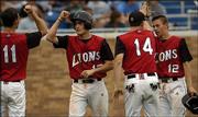 Lawrence High baseball players Will Falk (11) and John Novotny (14)
high five Matt Falk and Nick Madl (12) after Falk and Madl scored
against Free State High. The Lions were trailing the Firebirds,
though, when Thursday night's game was suspended because of rain.
