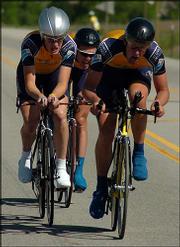 Members of the Fort Lewis College team -- from left, Matt Shriver,
Dan Bowman and Chris Kuhl -- labor during the team-time-trial stage
of the National Collegiate Cycling Championships. Fort Lewis won
the men's Division One race.