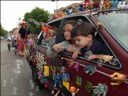 Layla Wilson, left, and Benjamin Slimmer peek out of the "Toy Car." The two participated in the Art Tougeau Parade in 2002.