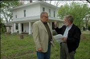 James Grauerholz, left, and Allen Belot, a local developer, talk about the history of the Hanscom house at 1503 Haskell Ave., which is scheduled to be razed to make way for a new development.