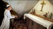 David Bawden, who has taken the name Pope Michael I, prays in a chapel in the attic of his home near Delia. Bawden has claimed to be the rightful leader of the Catholic Church since he was elected by a handful of traditionalist Catholics in 1990.