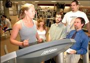 Kansas University psychology graduate students, from left, Jennifer Prohaska, Leslie Karwoski, Andy Lehman, Chris Heath and professor Stephen Ilardi are working on an alternative to drug therapy for treating depression. The program uses aerobic exercise, light therapy and other treatments to combat depression in people who aren't responding to prescription drugs. The group is pictured at the KU Student Recreation Center in this 2005 file photo.