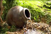 Jack Landgrebe's back yard is home to lots of surprises, including this pot fountain, which sends water gently splashing to rocks below.