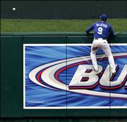 Kansas City center fielder David Dejesus comes up short as Alfonso Soriano's home run sails over the wall. The Texas Rangers beat the Royals, 14-9, Saturday in Kansas City, Mo.