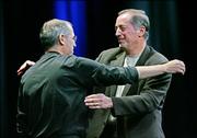 Apple Computer Inc. CEO Steve Jobs, left, hugs Intel Corp. CEO Paul Otellini at Apple's Worldwide Developers Conference in San Francisco. Apple announced it would discontinue using microprocessor chips made by IBM in favor of Intel chips.