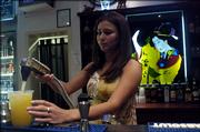 Aya Patterson, Lawrence, a bartender at the Moon Bar, pours a drink Tuesday night. The bar is decorated in an Asian motif, including stained-glass artwork of geisha girls behind the bar.