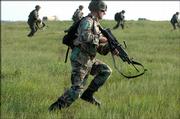 Spc. Wesley Woods runs across a field at Fort Riley during a live ammunition assault on a mock village. Woods, 23 from Nashville, is in the 1st Battalion, 16th. Infantry, which is scheduled to deploy to Iraq later this year. The efforts of Woods and other troops are recorded by military history detachments, including the Wichita-based 101st Military History Detachment.