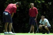 Gary Woodland putts on the 11th green under the watchful eyes of teammate Tyler Docking, center, and Chris Mabry during the KGA Four-Ball championship. Woodland and Docking, also Kansas University teammates, were tied with Missouri's Mabry and John Kelly when play was suspended Sunday at Alvamar Golf Course.