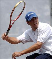Andrew Marchetti, above, and Branden Joost will face James Rudnick and Eddie Lorenzo for the right to play Michael Strand and Eduardo De Anda for the men's open doubles title when play in the Lawrence Adult Open tennis tournament resumes.