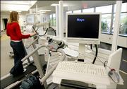 The Mayo Clinic logo flashes across a workstation in Rochester, Minn., that combines a computer, desk and treadmill into one unit. It's what obesity researcher Dr. James Levine calls the "ultimate office makeover." Instead of workers sitting in front of their computers, they can walk on the treadmill and work.