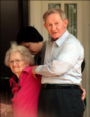 Charles Robert Jenkins, right, along with his wife, Hitomi Soga, background, escort his mother, Pattie Casper, back into his sister's home in Weldon, N.C. Jenkins, an Army deserter, returned home Tuesday for the first time since he defected to North Korea in 1965.