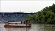 Tom Farris, of Edwardsville, who owns the "Spirit of the Kaw," pilots the houseboat along the Kansas River. Farris and Laura Calwell, the Kansas Riverkeeper for Friends of the Kaw, recently toured the river around Lawrence.