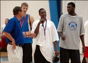 Kansas University coach Bill Self, left, introduces the incoming freshmen, from left, Micah Downs, Mario Chalmers and Julian Wright during Self's basketball camp. The Jayhawks held a workout to show the campers how hard they work between games during camp Tuesday at Horejsi Center.